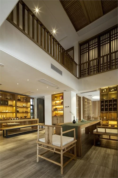 Double-height tea room framed by timber latticework and display walls