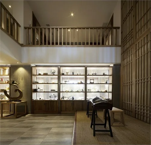 Backlit ceramic display cabinets beneath the upper timber gallery
