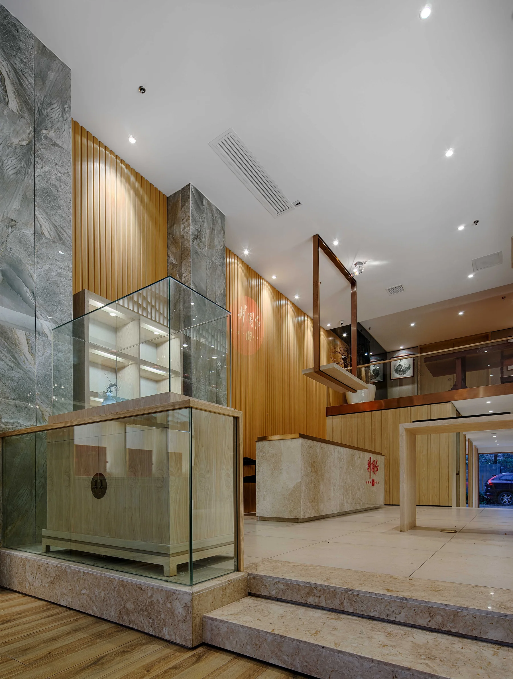 Glass tea cabinet and stepped timber display platforms in the lobby